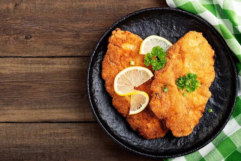 Wiener Schnitzel with lemon in a pan, Viennese cuisine near Hotel Boltzmann