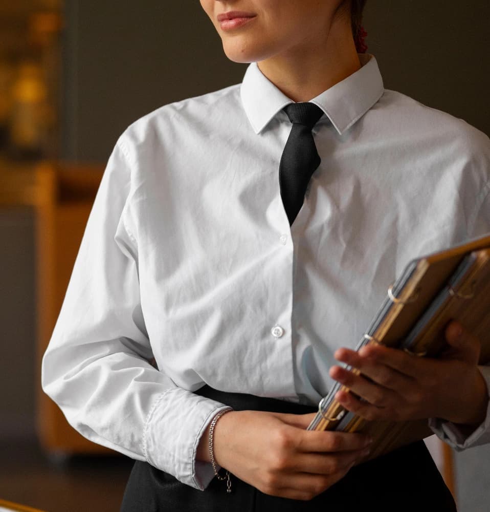 Hotel Boltzmann team member holding guest folders